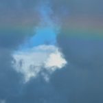Rainbow against dark clouds